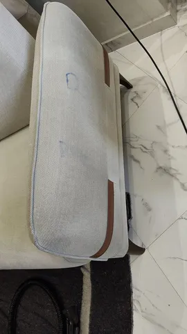 Coussin de fauteuil gris taché, avant le nettoyage NADIFA